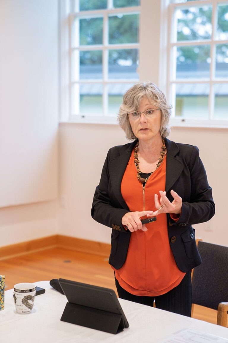 Lynne Rozenboom speaking to a group in a coaching session